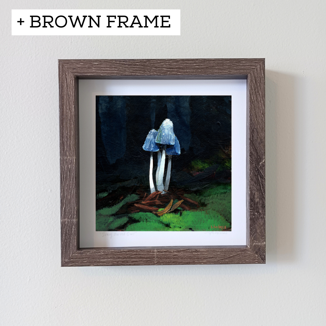 An art print of a young shaggy mane mushroom in a brown frame on a white wall.