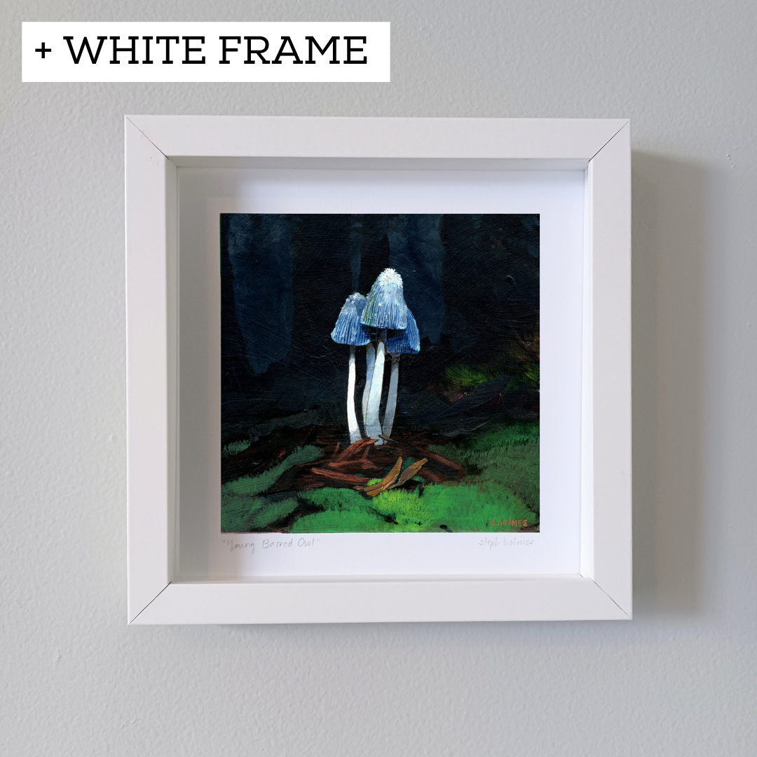 An art print of a young shaggy mane mushroom in a white frame on a white wall.